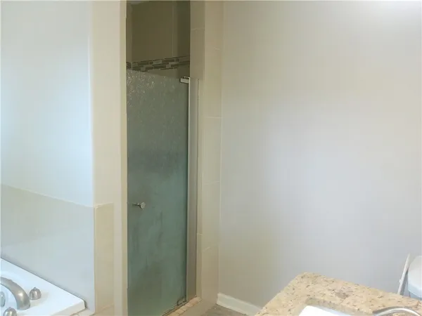 a bathroom with a granite countertop sink
