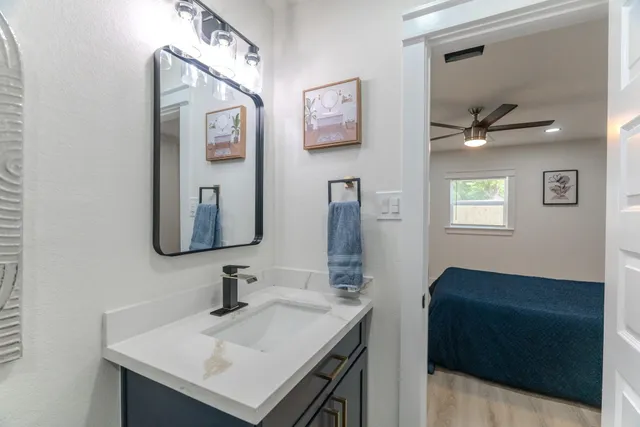 a bedroom with furniture and a ceiling fan