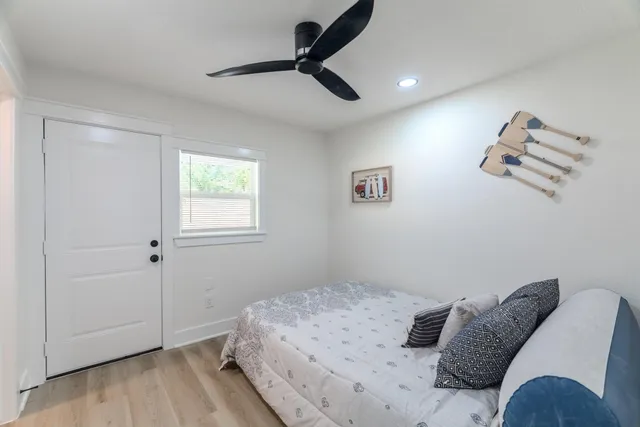a bedroom with a bed and wooden floor