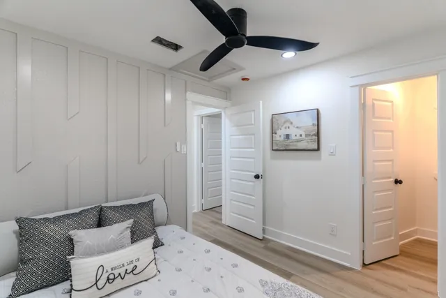a bedroom with furniture and a ceiling fan