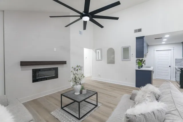 a living room with furniture and a wooden floor