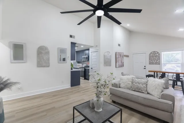 a kitchen that has a sink wooden cabinets and stainless steel appliances