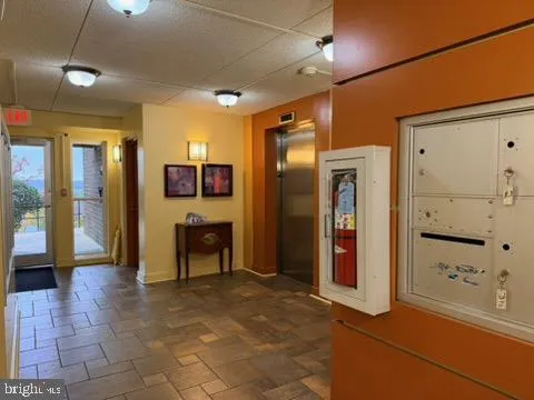 a view of a hallway with wooden shelves