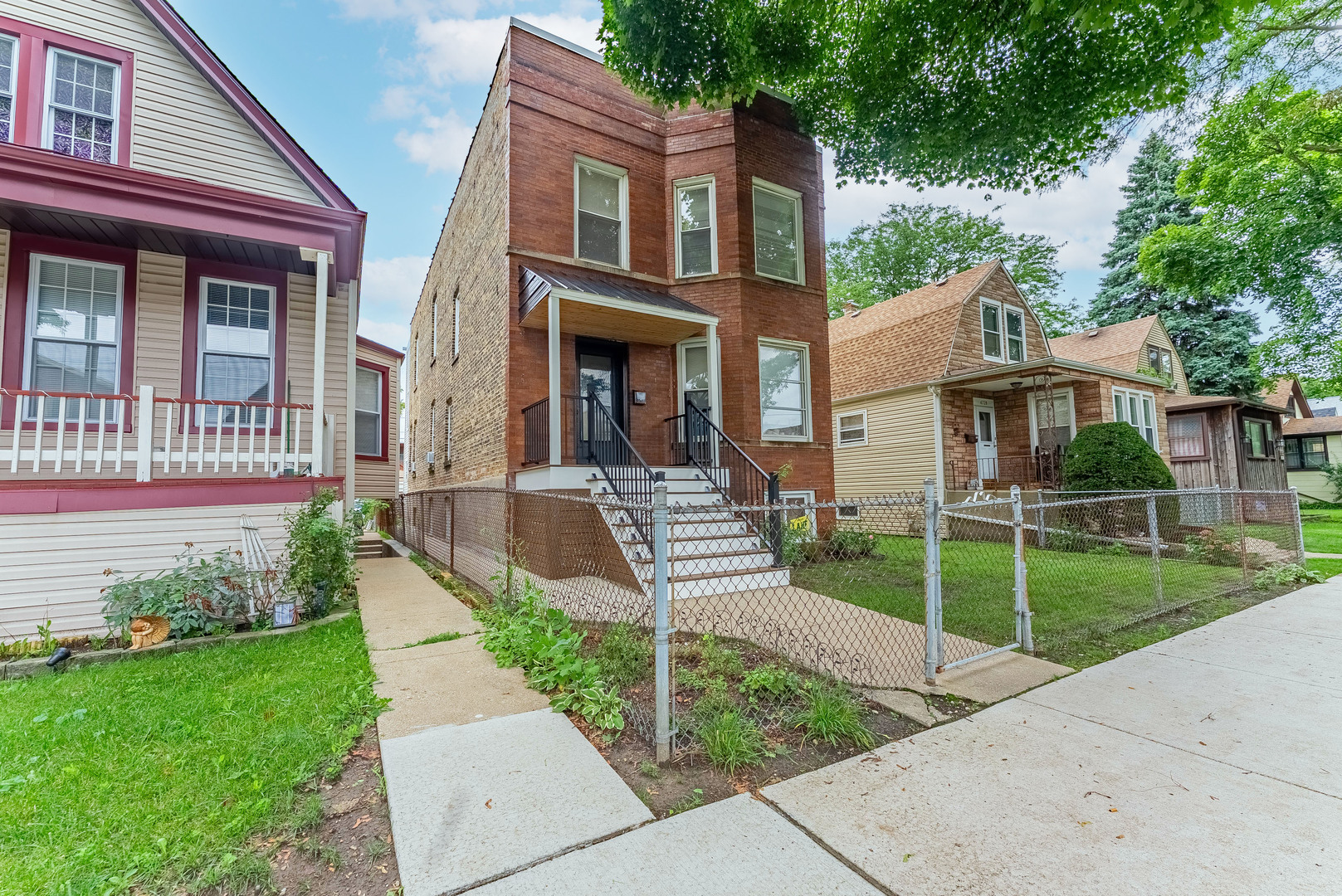 4730 West Warwick Avenue, Unit 2 Chicago, IL 60641 - Photo 2 of 26 a front view of a house with a garden and plants