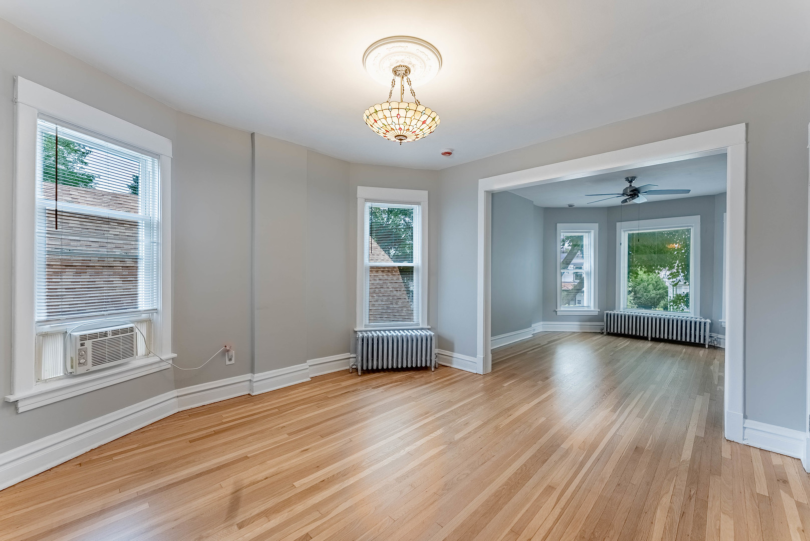 4730 West Warwick Avenue, Unit 2 Chicago, IL 60641 - Photo 5 of 26 a view of empty room with wooden floor and fan