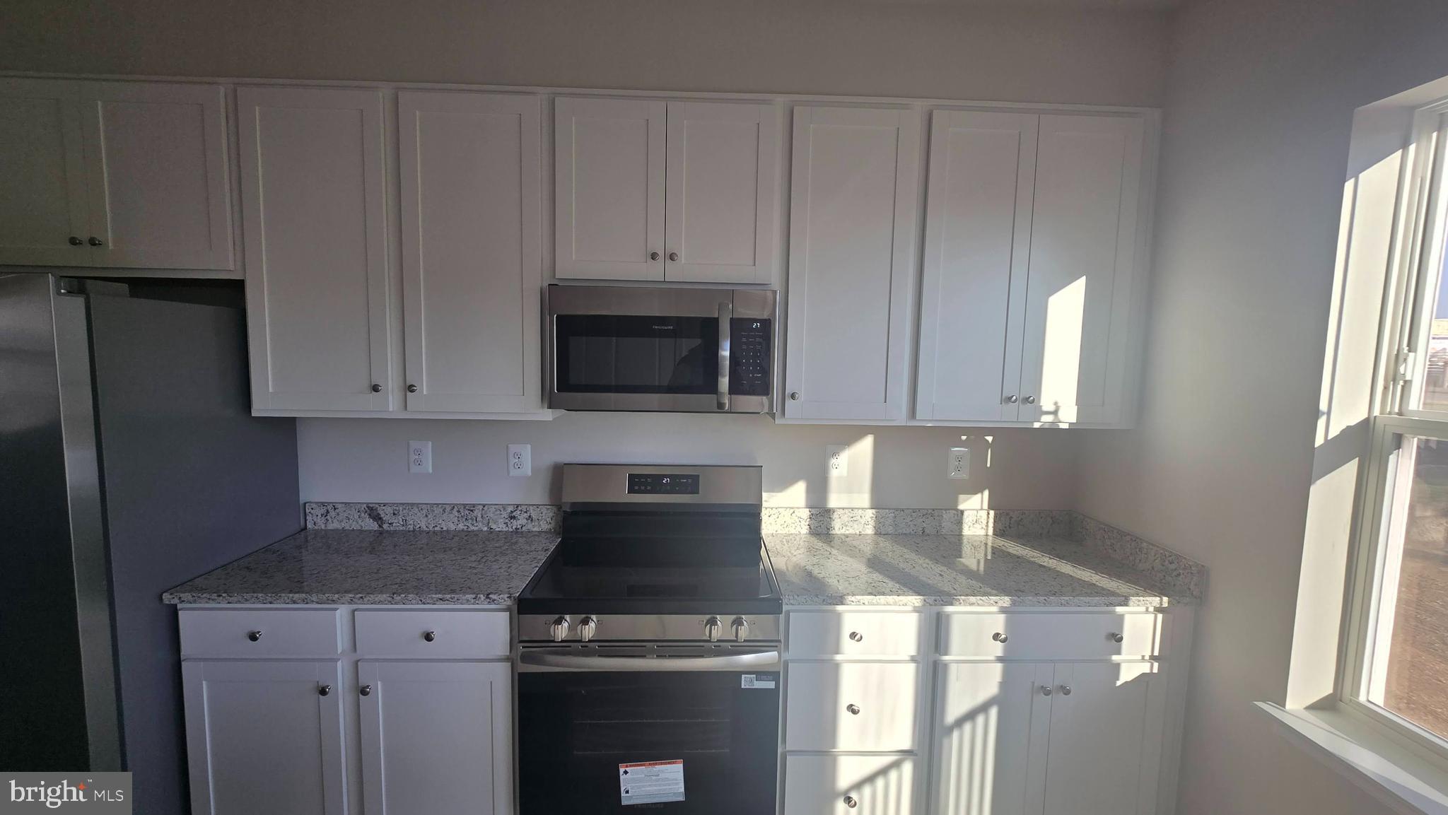 36 Canning Road Inwood, WV 25428 - Photo 21 of 29 a kitchen with stainless steel appliances granite countertop a stove a refrigerator and a microwave