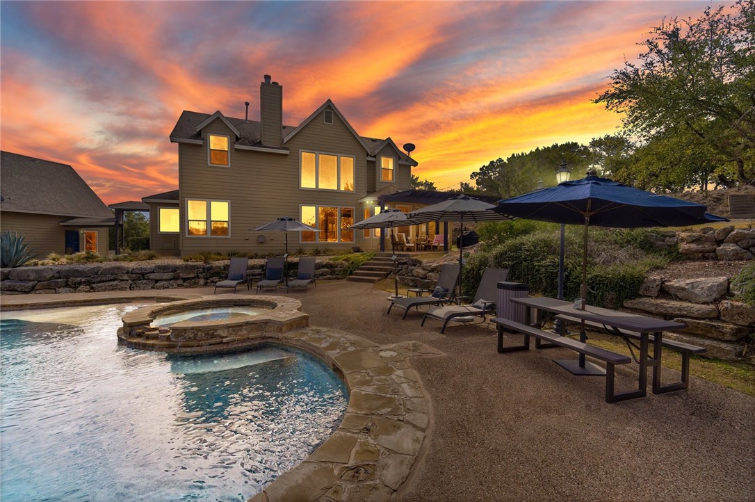 a view of a house with swimming pool and sitting area