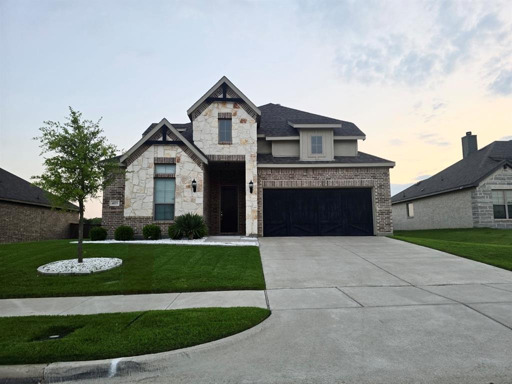 4033 Garden Grove Road Midlothian, TX 76065 - Photo 1 of 1 French provincial home featuring a garage, driveway, a lawn, and stone siding