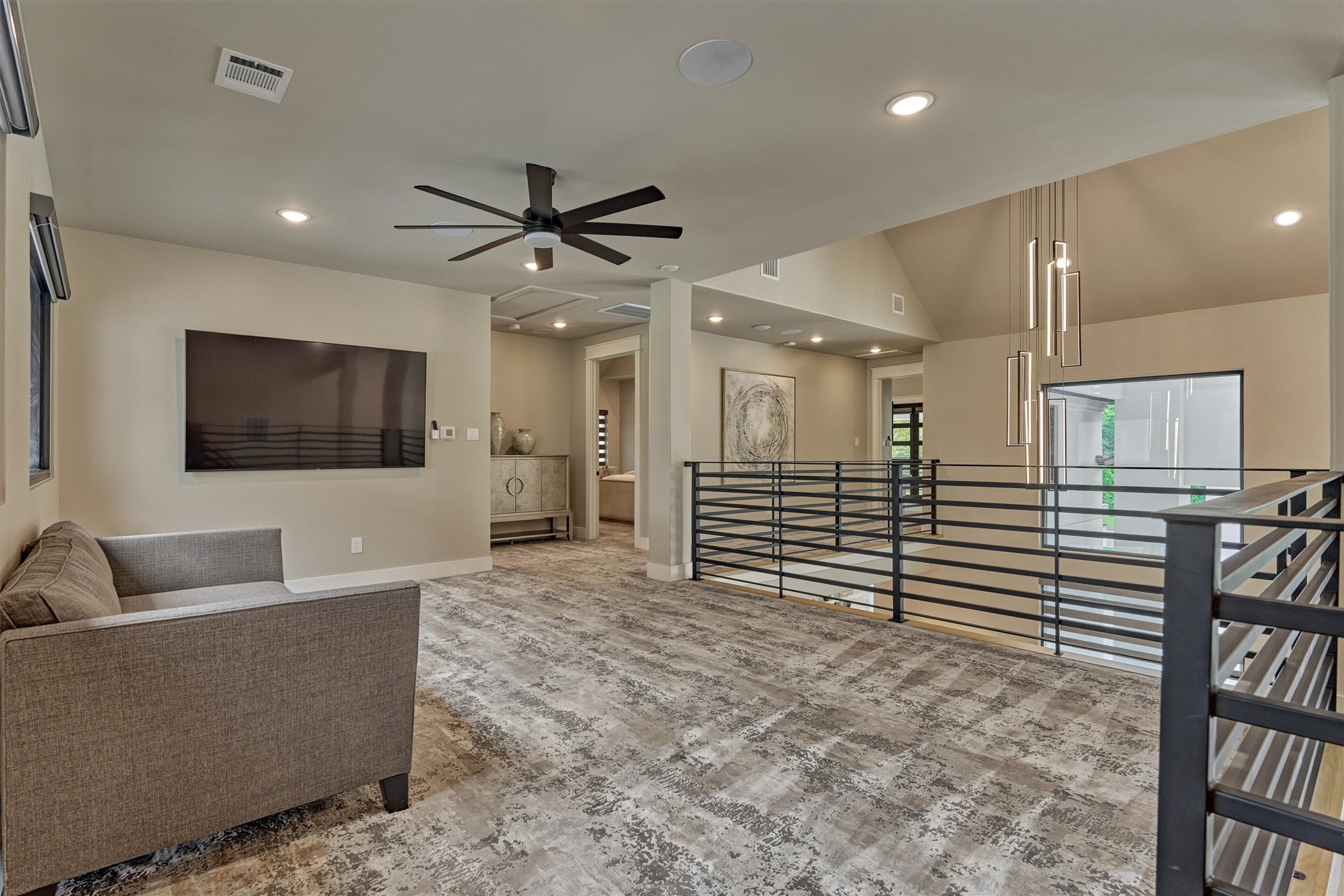 1907 Woerner Road Houston, TX 77090 - Photo 34 of 50 Second floor of main home has designer carpet throughout! Modern iron horizontal railings outline this weloming flex space. Perfect for game room, office space or library area.