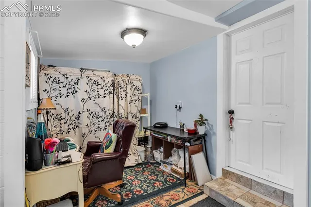 a view of a workspace with furniture and rug