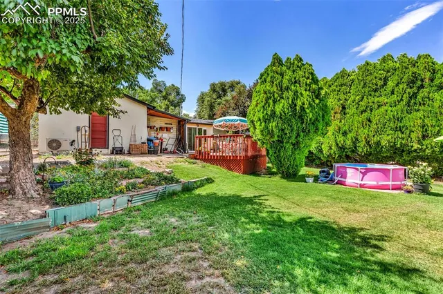 a view of a house with a yard and sitting area