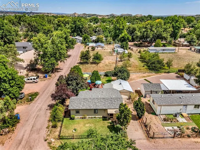 an aerial view of a house with yard swimming pool and outdoor seating