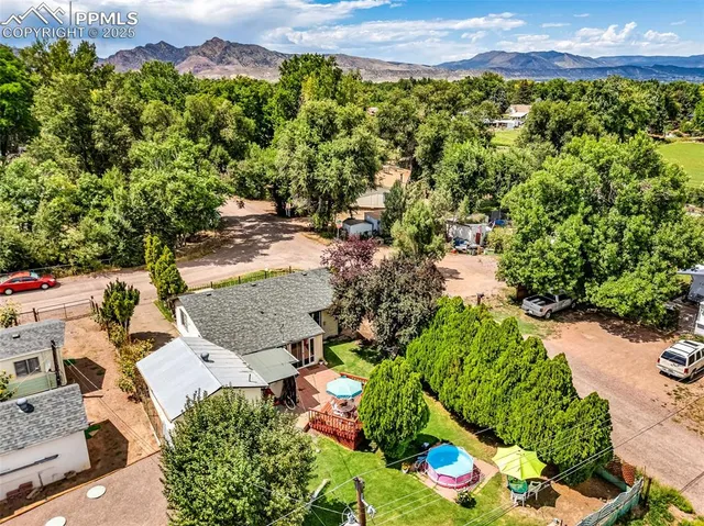 an aerial view of a house with a yard