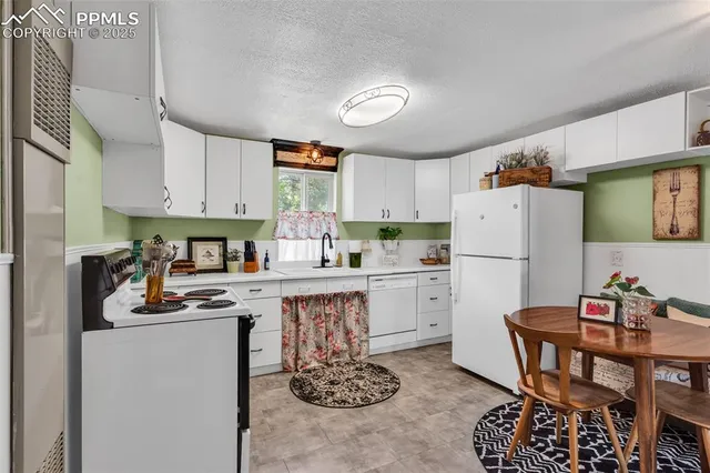 a kitchen with a dining table chairs refrigerator and cabinets