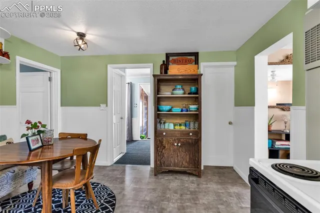 a living room with stainless steel appliances kitchen island granite countertop furniture and a refrigerator