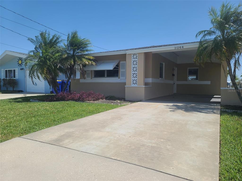 5044 Bonito Drive New Port Richey, FL 34652 - Photo 1 of 1 a front view of house with yard and green space