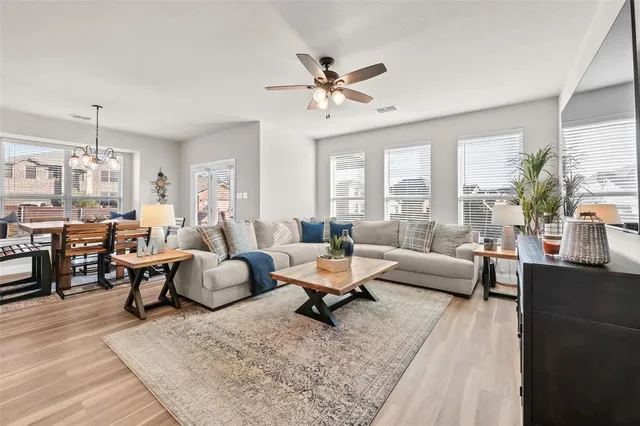 a living room with lots of furniture and a large window