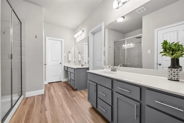 a spacious bathroom with a double vanity sink and a mirror