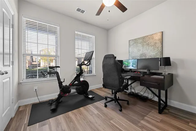 a view of a workspace with furniture and a window