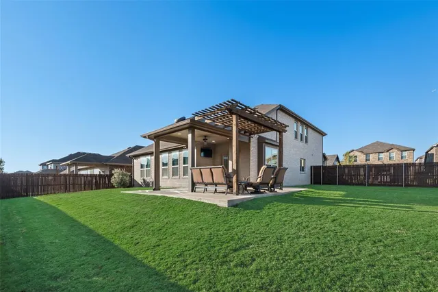 a view of a house with a yard and sitting area
