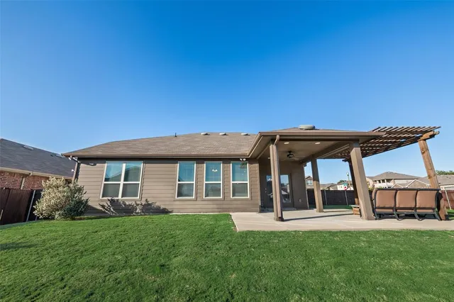 a view of a house with a backyard porch and sitting area