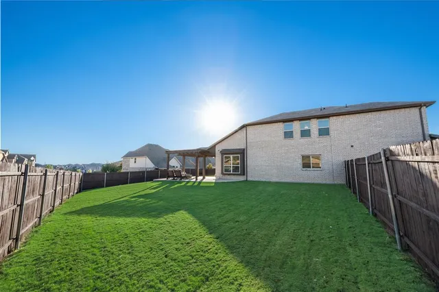 a backyard of a house with table and chairs