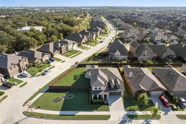 an aerial view of a house with a yard