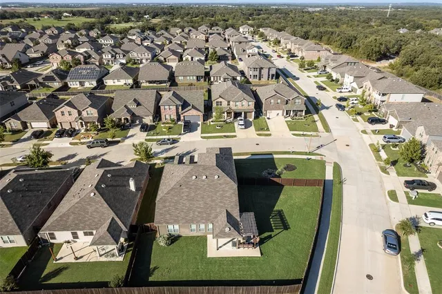 an aerial view of a residential houses with outdoor space