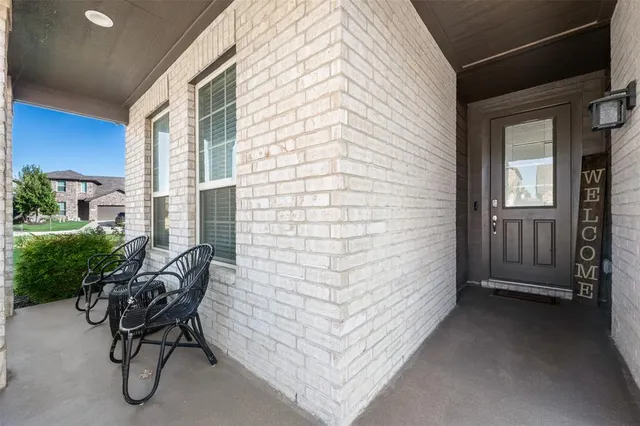 a view of a door and chair in the patio