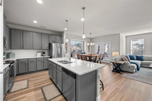 a kitchen with counter top space a sink cabinets and appliances