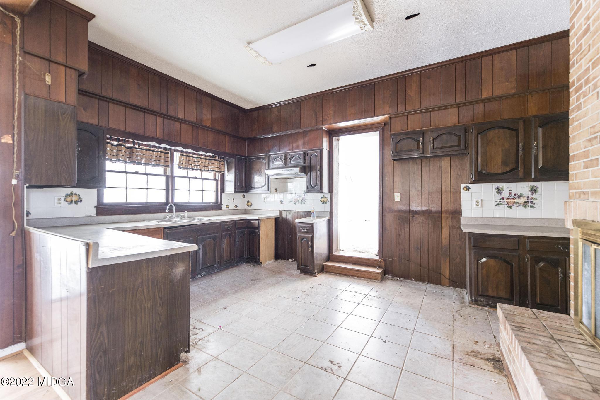 10 Mattie Road Fort Valley, GA 31030 - Photo 13 of 48 a kitchen with a stove a sink and a refrigerator