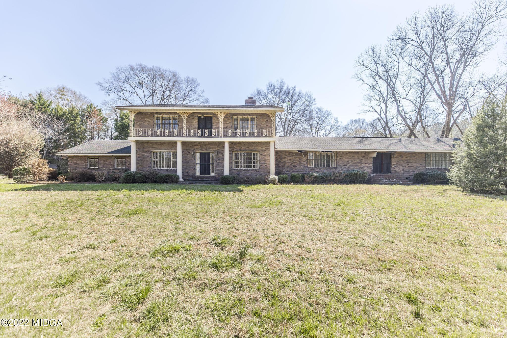 10 Mattie Road Fort Valley, GA 31030 - Photo 2 of 48 a front view of a house with a garden and trees
