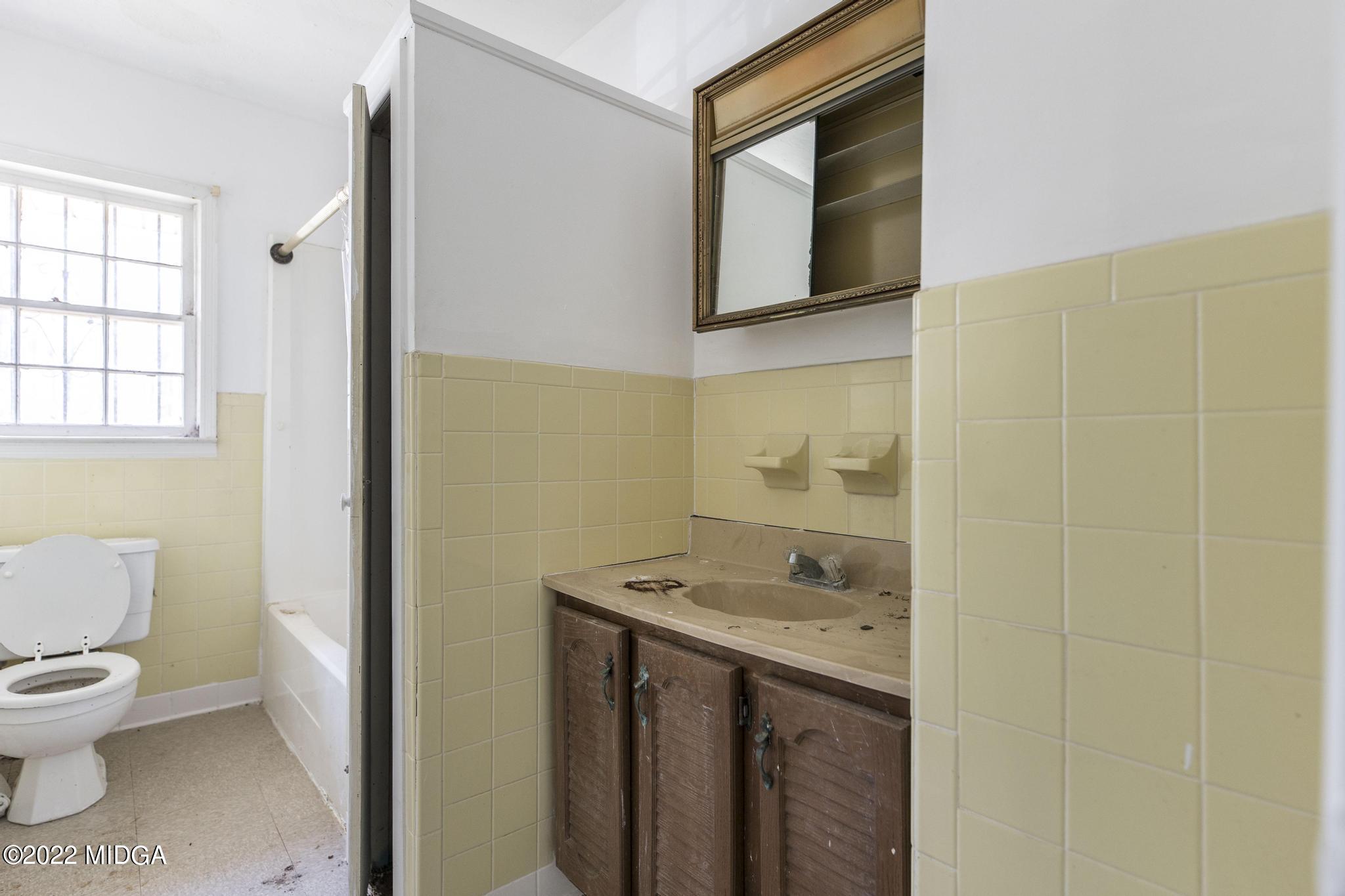10 Mattie Road Fort Valley, GA 31030 - Photo 24 of 48 a bathroom with a granite countertop sink toilet and mirror