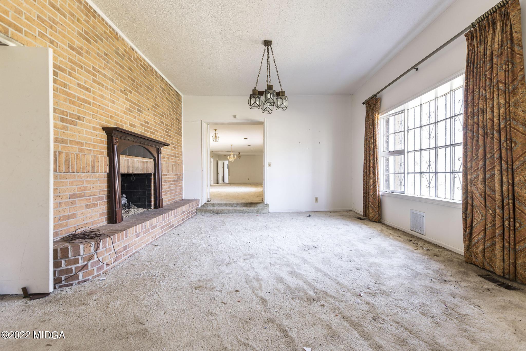 10 Mattie Road Fort Valley, GA 31030 - Photo 7 of 48 en empty room with windows and fireplace
