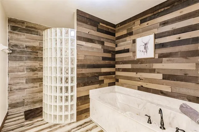 a bathroom with a bathtub and shower