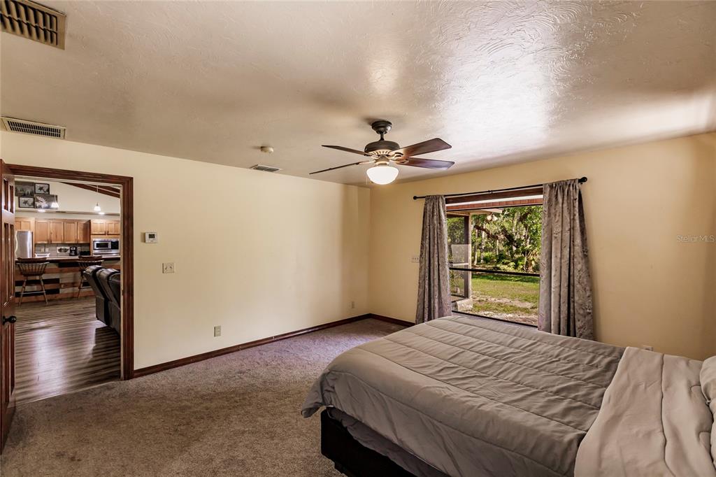 5826 Highway 72 Arcadia, FL 34266 - Photo 28 of 62 a bedroom with a bed and a chandelier