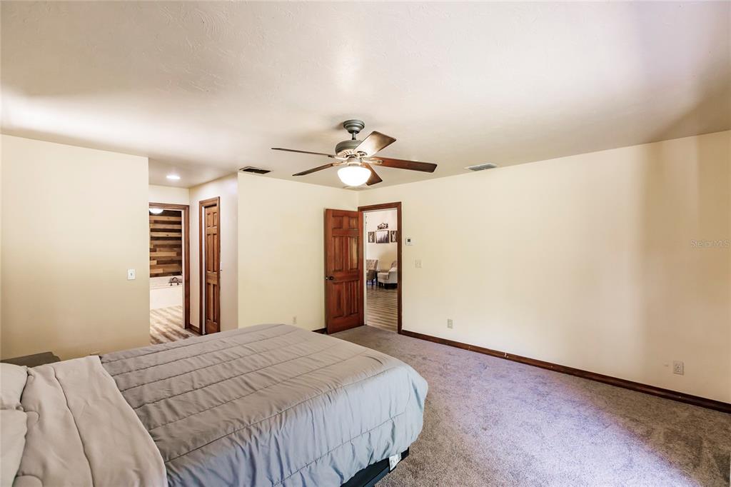 5826 Highway 72 Arcadia, FL 34266 - Photo 29 of 62 a bedroom with a bed and a chandelier