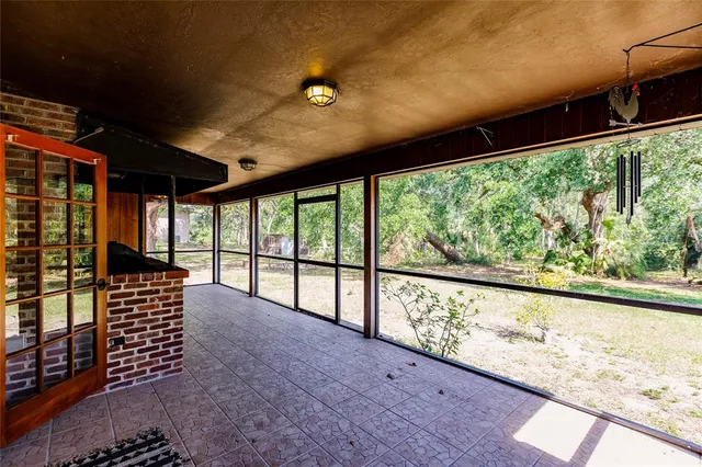 a view of porch with a floor to ceiling window next to a yard