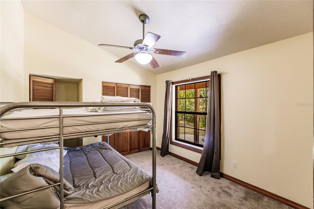 5826 Highway 72 Arcadia, FL 34266 - Photo 34 of 62 a bedroom with a bed and a chandelier