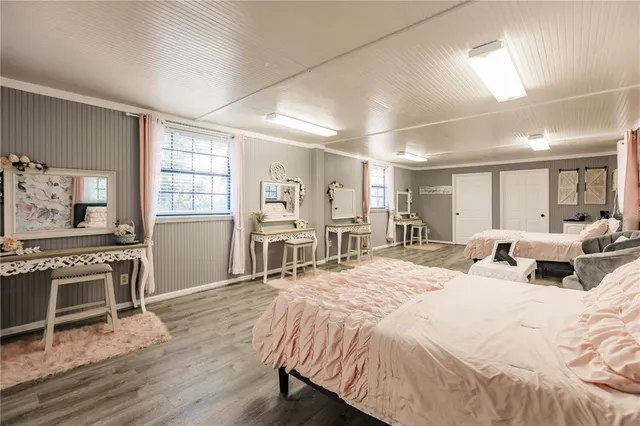 a spacious bedroom with a bed couch and a window