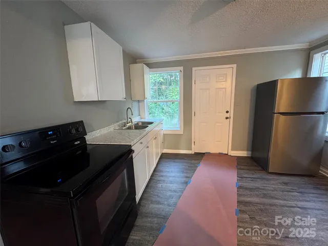 a kitchen with a refrigerator and a sink