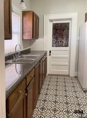 a bathroom with a sink a toilet a mirror and shower