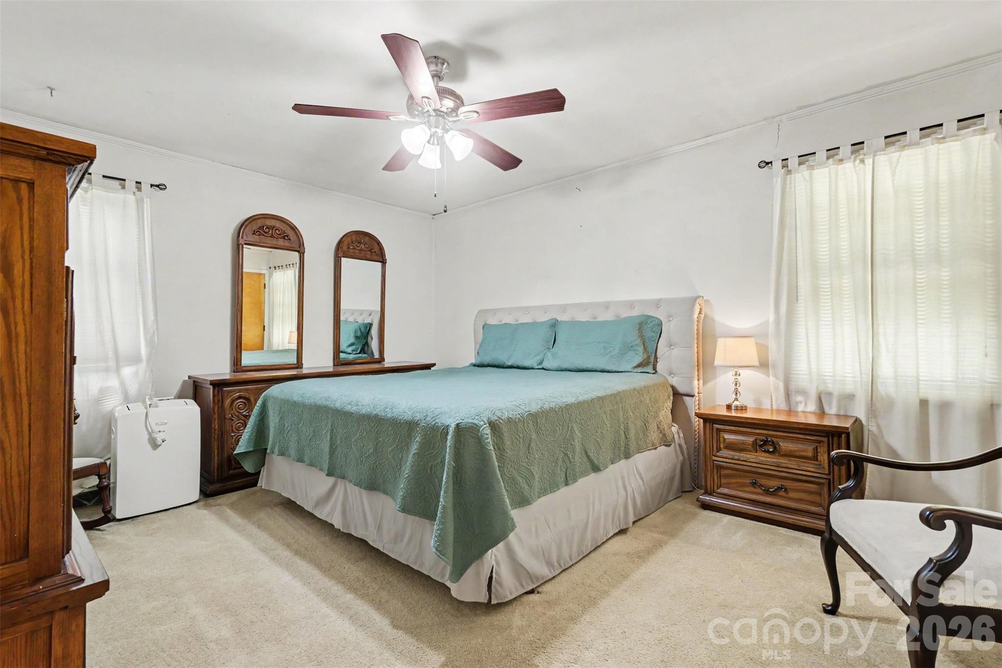 6774 Woodhaven Road Kershaw, SC 29067 - Photo 20 of 30 a bed room with a bed and a chandelier