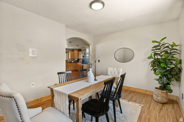 2013 North River View Road Huntsville, UT 84317 - Photo 16 of 53 Dining space featuring arched walkways and light wood-style flooring