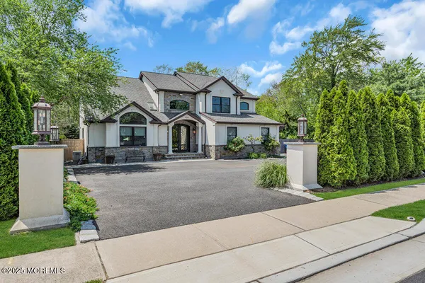 a front view of a house with a garden