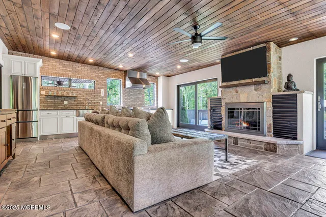 a bathroom with a granite countertop sink a mirror and a shower