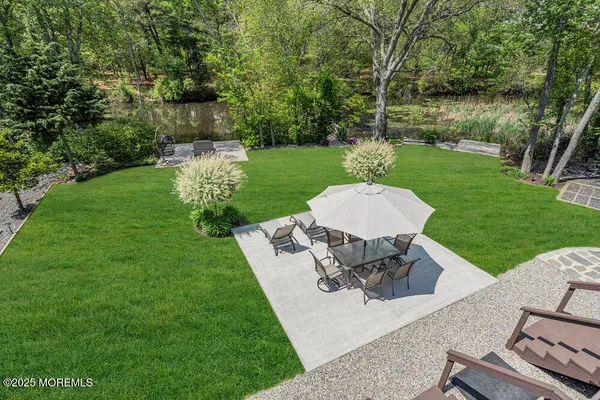 a view of a garden with a lush green forest