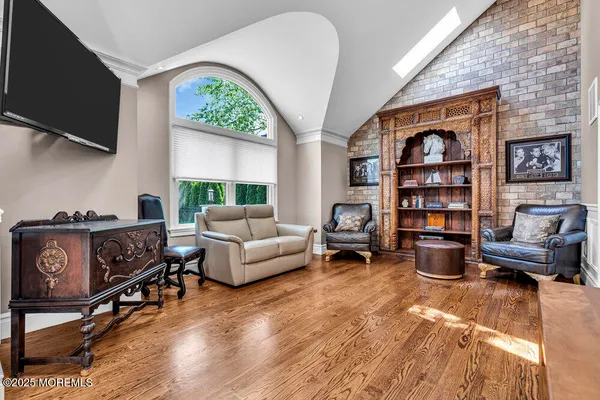 a kitchen with stainless steel appliances a dining table chairs microwave and sink
