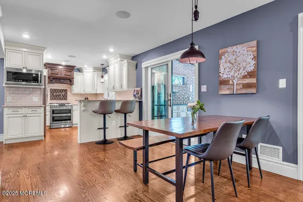 a kitchen with a stove a sink and a microwave