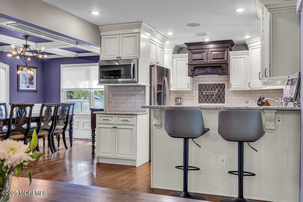 620 Brookside Drive Toms River, NJ 08753 - Photo 9 of 88 a kitchen with stainless steel appliances a dining table chairs microwave and sink